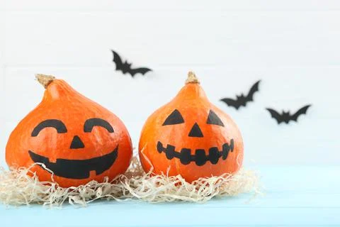 Pumpkins with painted faces on a colored background for Halloween. Stock-Fotos