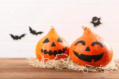 Pumpkins with painted faces on a colored background for Halloween. Photos