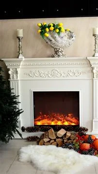 Pumpkins rest beside pinecones, soft white rug enhances warmth, glowing flames Stock Photos