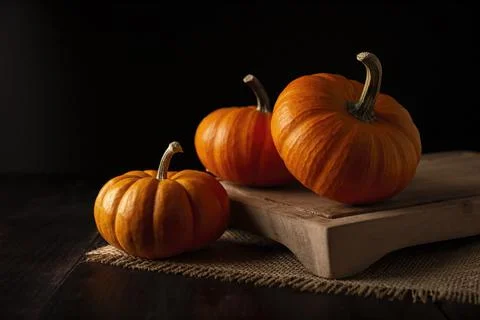 Pumpkins on rustic wooden table. Pumpkins are widely grown for commercial use Stock Photos