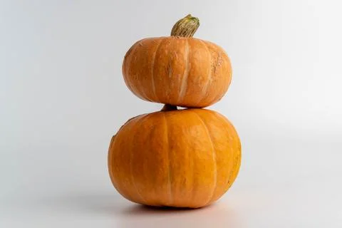 Pumpkins stacking on white background for autumn harvest Stock Photos
