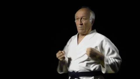 Punch and block with hand in slow motion is trained by an old man athlete Video stock 142340435