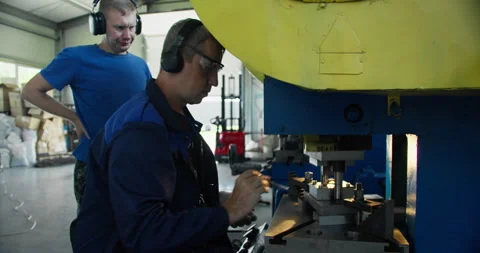 Punch press operator working at metal stamping machine Stock Footage 336301932