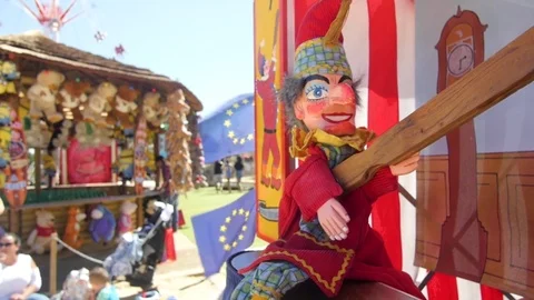 A punch puppet waving a stick in front of EU flags Stock Footage 84650751
