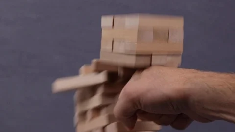 Punch to wood blocks tower game, business finance and architecture risk Stock Footage
