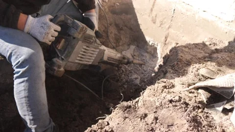 Puncher Beats Concrete Wall. Drilling a Hole with a Large Hole Punch Stock Footage 304624519