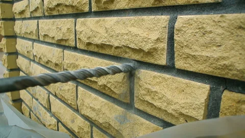 Puncher drill close up brick wall outdoors decorative facade Stock Footage 139330512