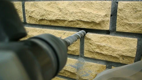 Puncher drill close up brick wall outdoors decorative facade Stock Footage 139330593
