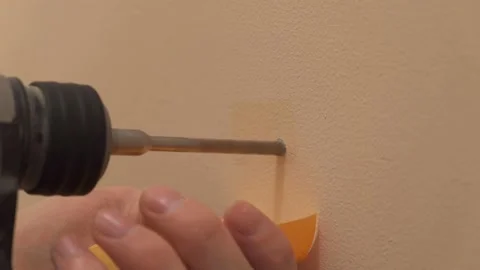 The puncher makes a hole in the wall Video stock 165989216