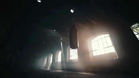 Punching bag in a deserted room up-angle Stock Footage 135390180