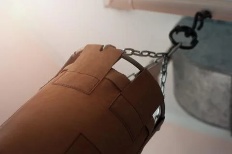 Punching bag hanging on chains on the ceiling Stock Photos