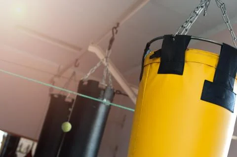 Punching bag hanging on chains on the ceiling Stock Photos