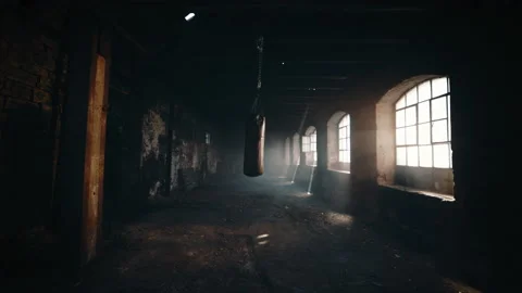 Punching bag swinging back and forth in a deserted building Stock Footage 135390147
