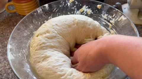 Punching Down Proofed Bread Dough in a Glass Bowl Stock Footage 344785511