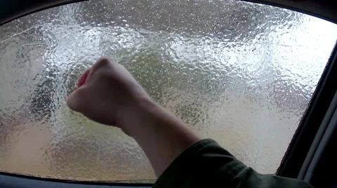 Punching out frozen window Stock Footage 34351351