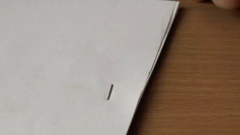 Puncture of paper with a stapler Stock Footage 79851785