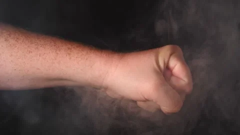 Punish through the smoke in slow motion close up man's hand Video stock 206655205