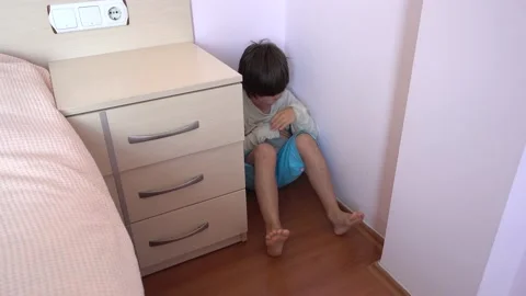 Punished boy sits in the corner and suddenly screams Stock Footage 131657589
