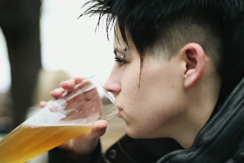 Punk girl during conversation drinking beer in bar, steadicam shot NTSC Stock Footage