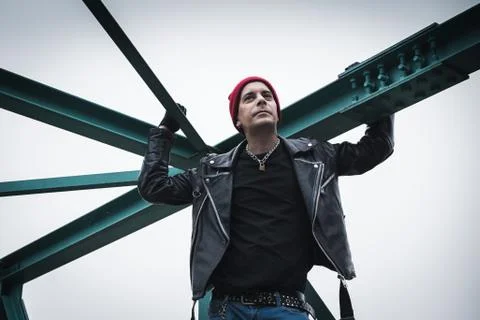 Punk guy standing on a bridge Stock Photos