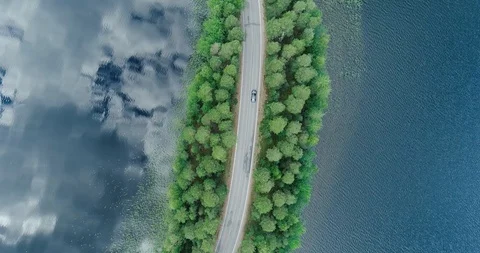 Punkaharju Finland, camera going down and car passes on the road Stock Footage 94345355