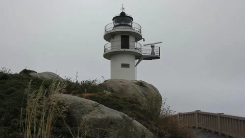 Punta Roncadoira lighthouse in a cloudy day Stock Footage 312526298