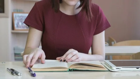 Pupil girl sitting at desk reading school tutorial Stock Footage 72533853