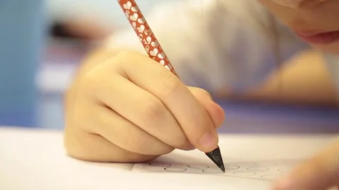 Pupil at the school wrote on a piece of note paper for boys Stock Footage 80870874