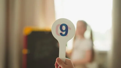 Pupil shows digit solving maths problems with sister at home Stock Footage 249309570