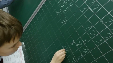 A pupil solves math on the school blackboard at primary school, 4k shot Stock Footage 62500688