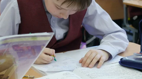A pupil solves math while sitting at a desk in the classroom, Full HD shot Stock Footage 62530392