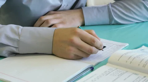 Pupil solves the problem in a notebook in math Stock Footage 68799652