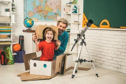 Pupil studies astronomy with funny teacher. Pupil enjoy time with teacher father Stock Photos