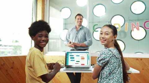 Pupil study programming system while turn around to look at camera. Edification Stock Footage 265030488