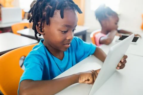Pupil using a tablet pc in classroom Foto stock