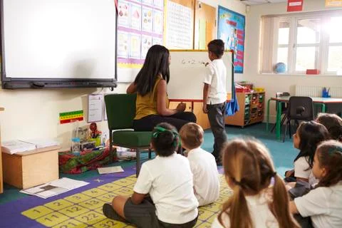 Pupil At Whiteboard In Elementary School Maths Class Stock Photos