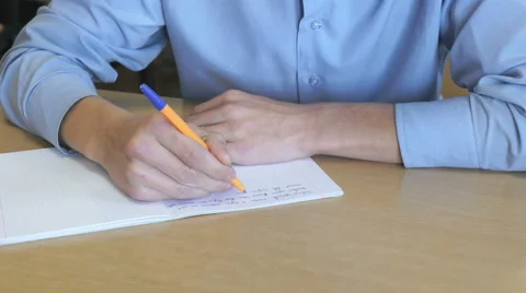Pupil writes text in a notebook indoors 動画素材 68822399
