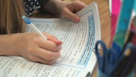 Pupil writes the text in a notebook indoors Stock Footage 71604080