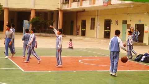 Pupils are playing basketball on the school basketball court Stock Footage 73290519
