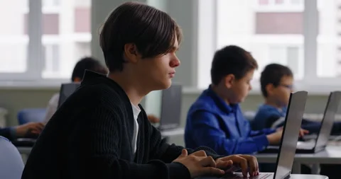 Pupils In Computer-Based Classroom Of High School, Teens Schoolboys Working With Stock Footage 280177676