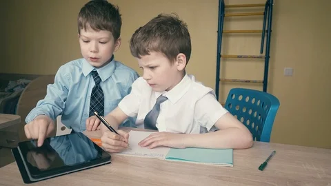 Pupils do homework, write numerals in notebooks, help each other Stock Footage 105098415