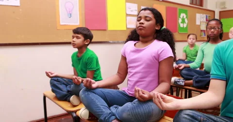 Pupils doing yoga in classroom Stock Footage 57649154