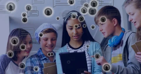 Pupils leaning over tablet in school studying, boy tapping screen causing Stockbeeldmateriaal 329931102