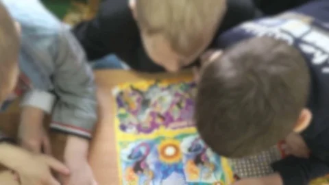 Pupils reading a book in a classroom Stock Footage 71776941
