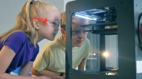 Pupils, schoolchildren look at 3d printer. Back to school concept. Stock Footage 93560755
