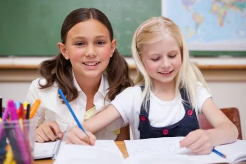 Pupils working together on an assignment Stock Photos