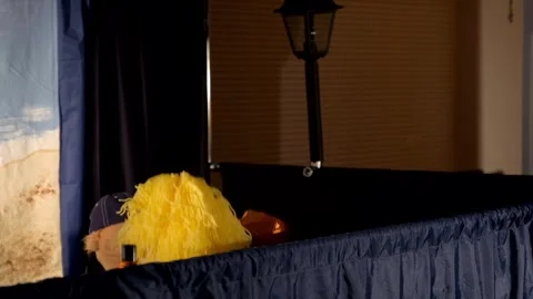 Puppet Characters Performing Behind Draped Stage in Indoor Theater 動画素材 340886884