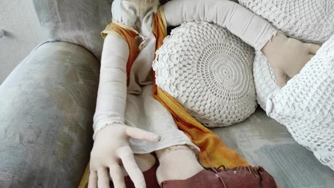 A puppet in form of an old man sitting on a couch Stock Footage 313337212