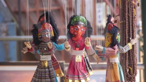 Puppet Hanging By Their String Near Necklaces - Handheld Stock Footage 80637127