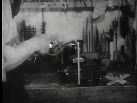 A puppet-master rigs the strings that will control the marionette he is making Stock Footage 75284419